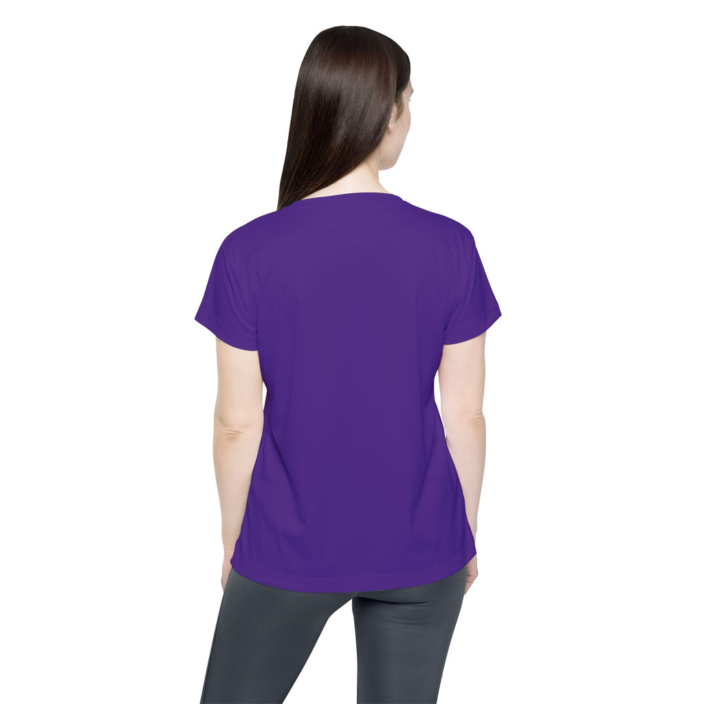 A woman with long brown hair stands with her back to the camera, wearing a plain purple Straight Outta Baltimore — Women's Sports Jersey and dark leggings against a white background.