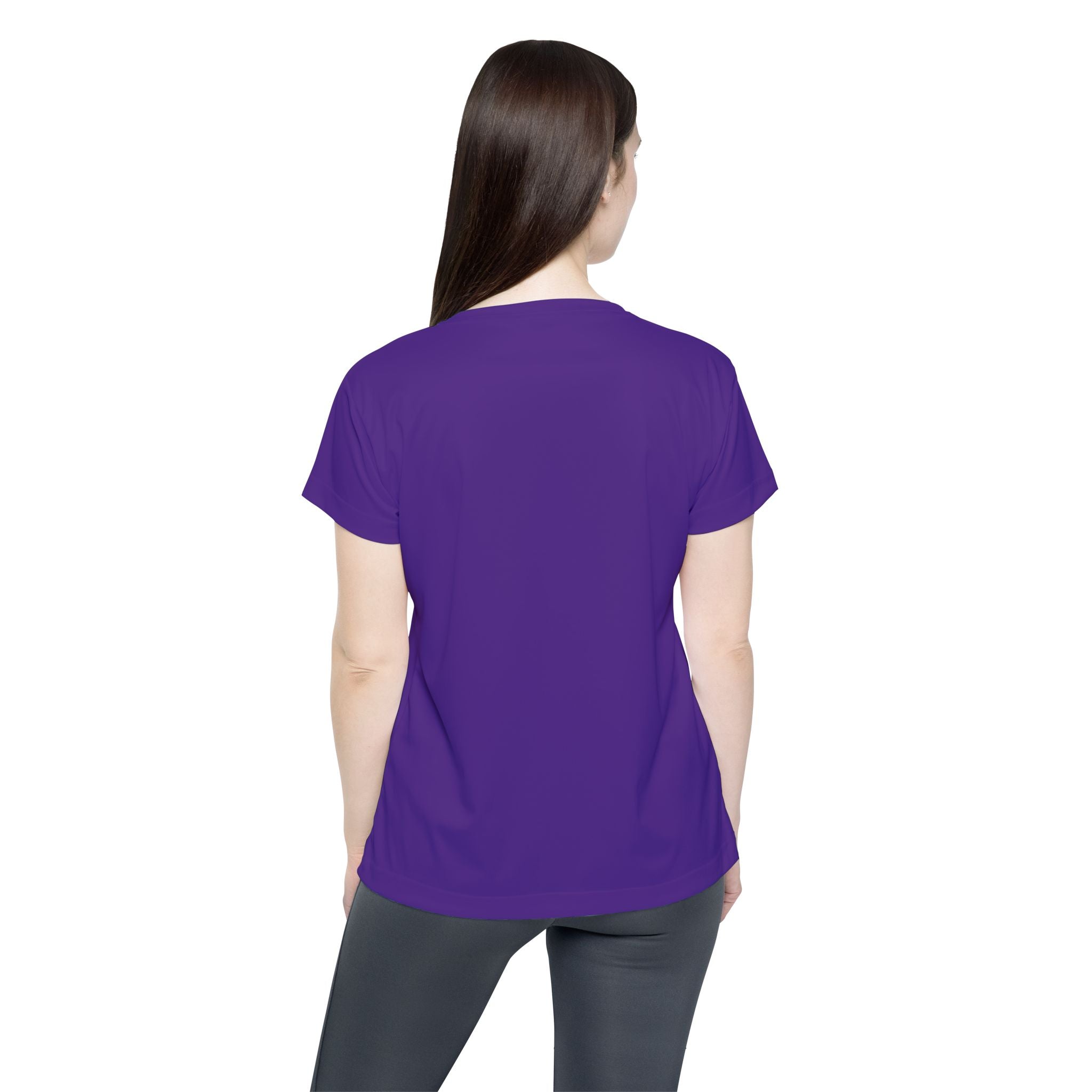 A woman with long brown hair stands with her back to the camera, wearing a plain purple Straight Outta Baltimore — Women's Sports Jersey and dark leggings against a white background.