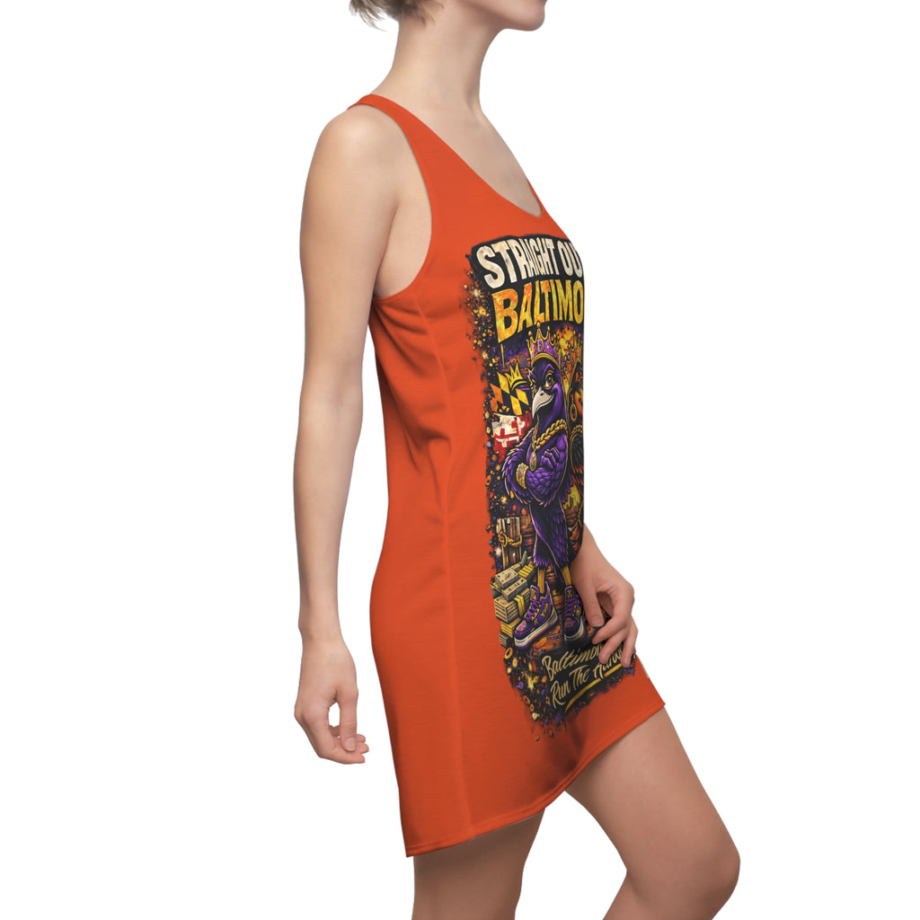 A woman wears the Orange Racerback Dress - Straight Outta Baltimore - "Charm City Attitude," featuring quick-dry polyester, a vibrant graphic, and athletic sleeveless style, turned slightly to show off its sporty racerback design.
