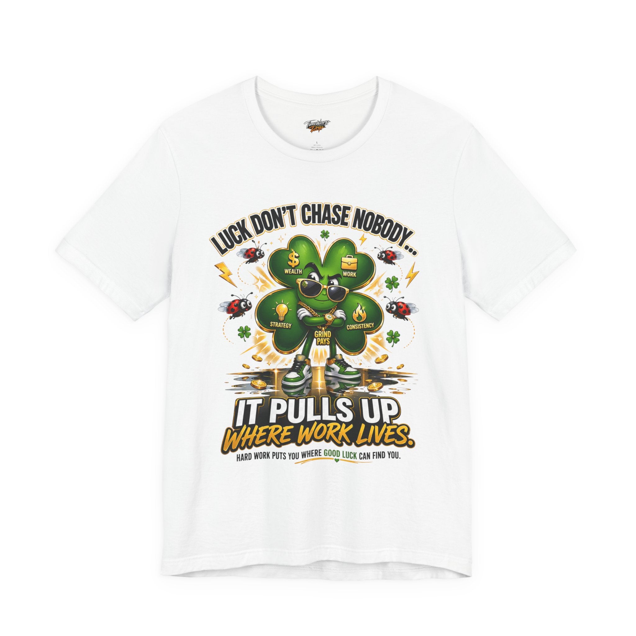 The Lucky Clover "Pulls Up Lives" Graphic T-Shirt is a white tee in S, M, L, XL, and plus sizes. It features a four-leaf clover with sunglasses and sneakers and the text: Luck don’t chase nobody... Hard work puts you where good luck can find you.