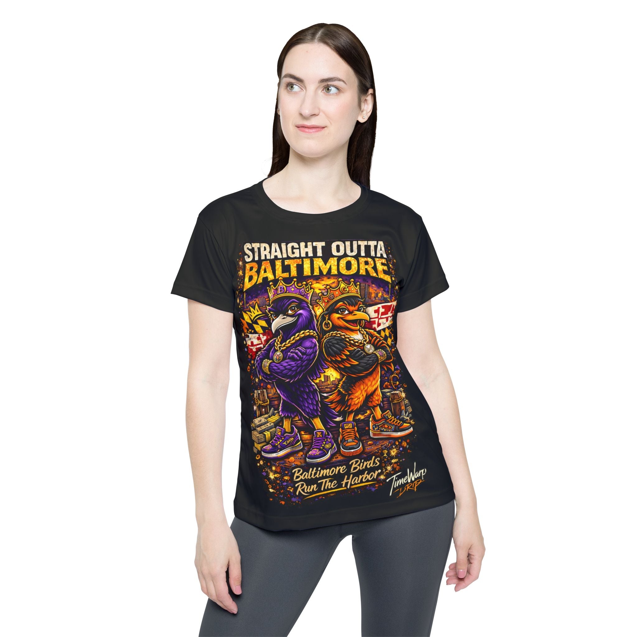 A woman with long brown hair wears the Printify "Straight Outta Baltimore" Women’s Sports Jersey, a black Charm City fan tee featuring two cartoon birds and bold, colorful text.