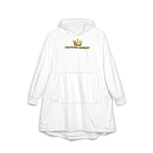 Stay cozy in the "Crowned in Every Era" Royal Chess Graphic Hooded Blanket (White), featuring an oversized fit, front pocket, wrap-style long sleeves, and hood. The chest displays a gold crown graphic above bold yellow “CROWNED ENERGY” text. One size fits most.