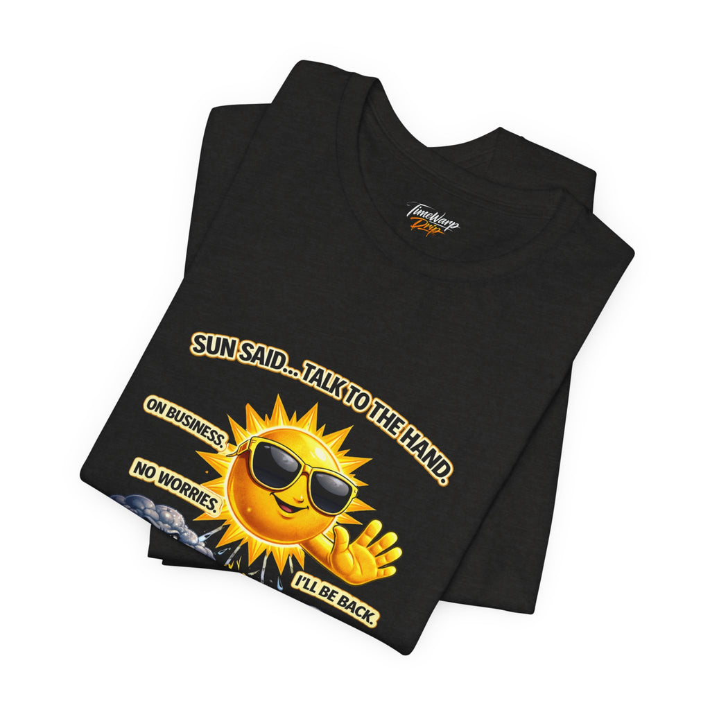The Printify Calm Energy Vibes T-Shirt, "I Run the Forecast" CEO Energy, is a black lightweight Airlume cotton tee featuring a cartoon sun with sunglasses and raised hand. Text: SUN SAID... TALK TO THE HAND. ON BUSINESS. NO WORRIES, I’LL BE BACK.