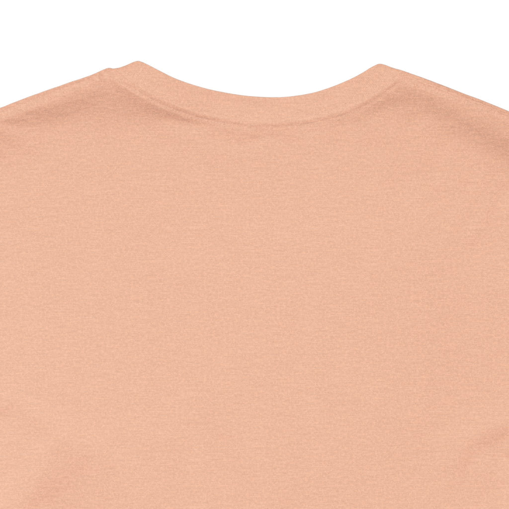 Close-up of the upper back of a TimeWarp Drip Lucky Clover "Pulls Up Lives" Graphic T-Shirt, shown in sizes S–3XL. Light peach color, soft fabric, no visible designs or logos on this portion, laid flat on a white background.