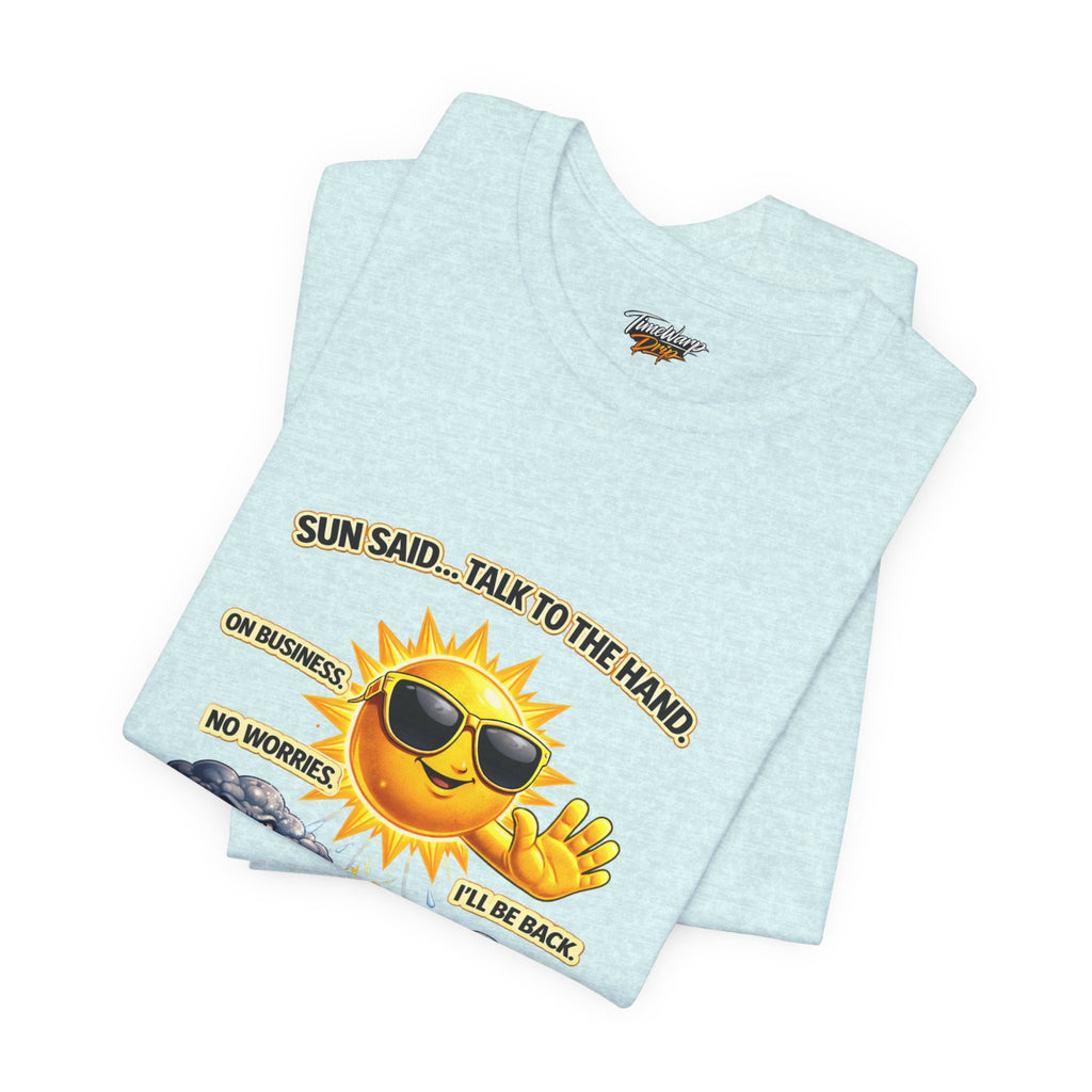 The Calm Energy Vibes T-Shirt — "I Run the Forecast" CEO Energy by TimeWarp Drip is a light blue Airlume cotton tee featuring a cartoon sun with sunglasses and the text: SUN SAID… TALK TO THE HAND. ON BUSINESS. NO WORRIES. I’LL BE BACK.