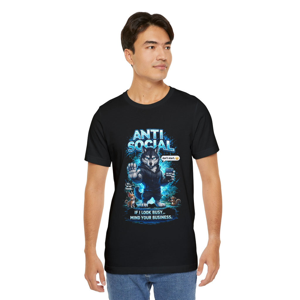 A young man wears the Timewarp Drip Anti Social Wolf T-Shirt, a streetwear tee for introverts, featuring a grumpy wolf graphic, "ANTI SOCIAL" text, "GET LOST" badge, and the phrase "If I look busy... mind your business.