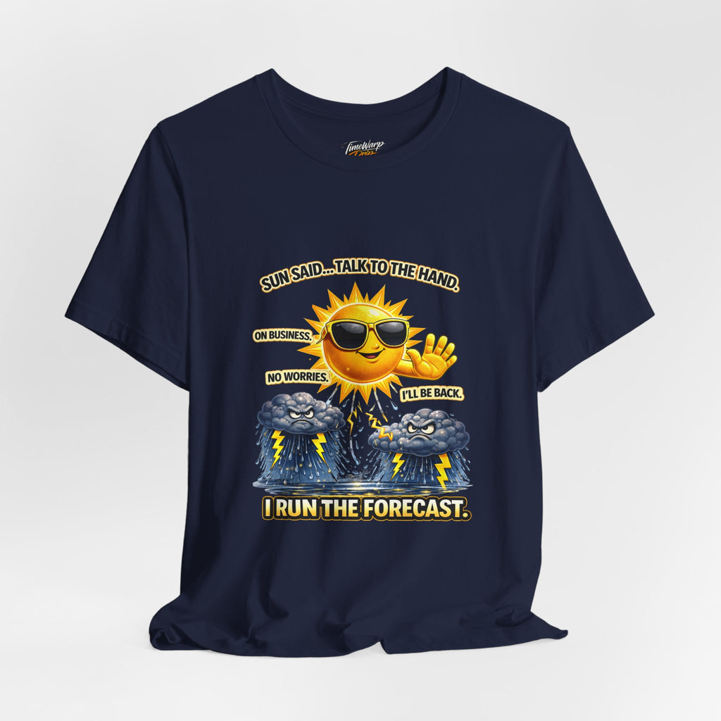The TimeWarp Drip Calm Energy Vibes T-Shirt — "I Run the Forecast" CEO Energy is a navy blue Airlume cotton tee with a smiling sun in sunglasses, hand raised, above storm clouds. Text: Sun said... talk to the hand. On business. I run the forecast.