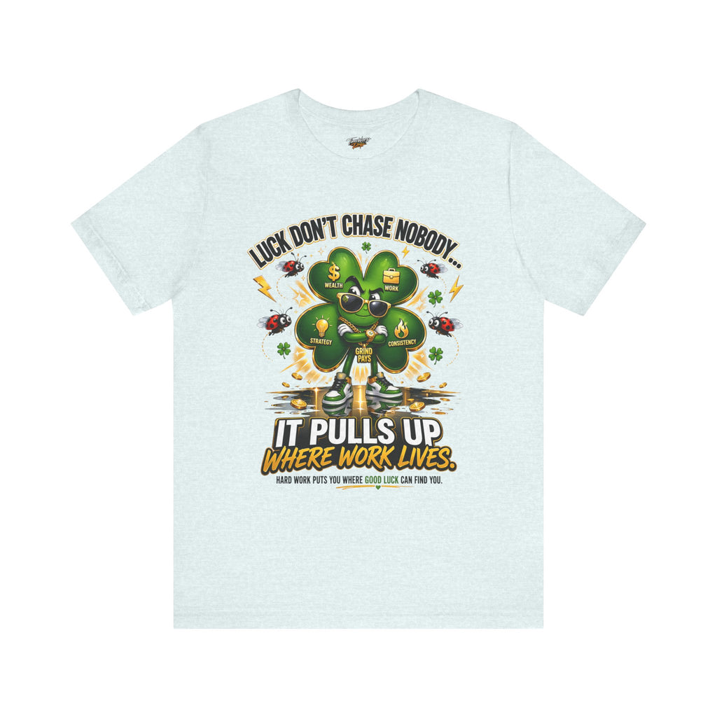 TimeWarp Drip's Lucky Clover "Pulls Up Lives" Graphic T-Shirt (S-3XL) in light gray features a green four-leaf clover, gold coins, career icons, and the quote: Luck don’t chase nobody. It pulls up where work lives. Hard work attracts good luck.